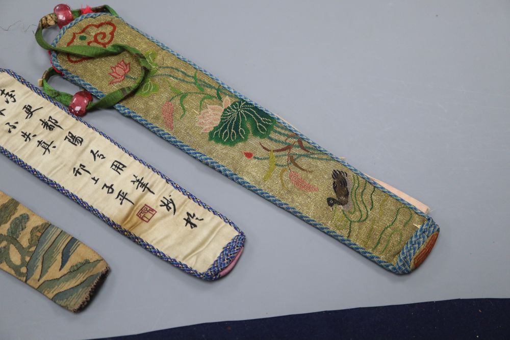 Three embroidered Chinese fan cases, one Kesi and woven with a tree, river and temple motifs, another with fine embroidered duck and li